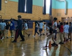 children in a gym playing basketball