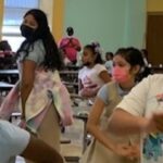 Elementary school girls practicing cheerleading 