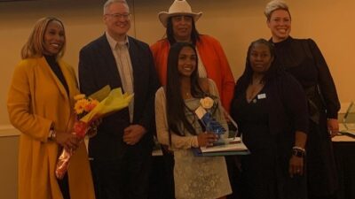 Picture of five young women along side County Executive Dan Benson. one of the young women, Rithika Bodicherla is pictured with her award for Young Woman of Achievement.