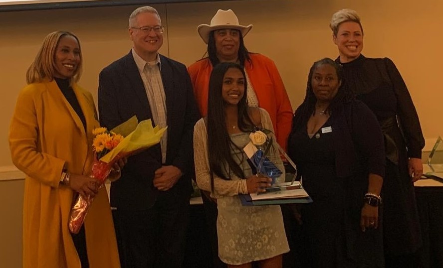 Picture of five young women along side County Executive Dan Benson. one of the young women, Rithika Bodicherla is pictured with her award for Young Woman of Achievement.